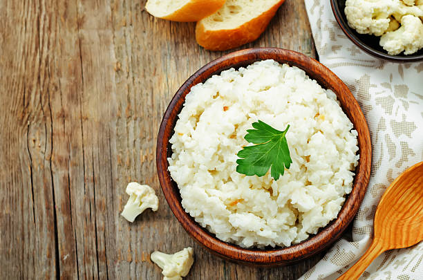 istock Creamy cauliflower garlic rice in a bowl on a wooden table 472840962