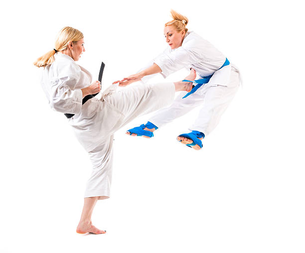 Same martial artist executing a knife hand and roundhouse kick.