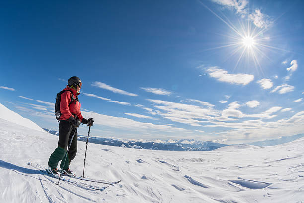 istock ski touring on sunny day 472848520