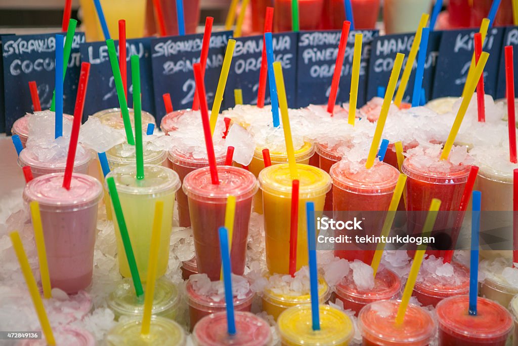 freshly squeezed fruit juice  at boqueria market in barcelona spain freshly squeezed fruit juice in cups at boqueria open market in barcelona spain 2015 Stock Photo