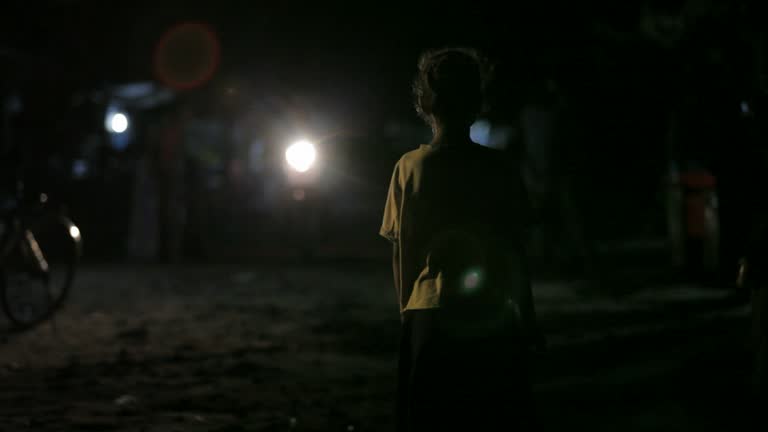 Cambodian street child in moving traffic, homeless girl