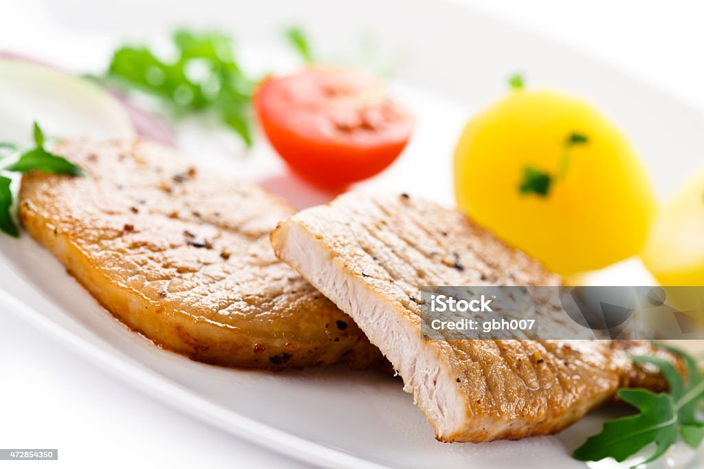 Grilled steak and vegetables on white background Grilled meat with vegetables  2015 Stock Photo
