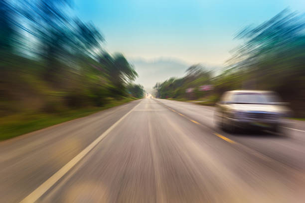 Motion blur of a rural road to infinity from inside a moving car