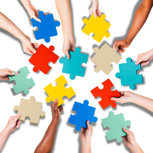 istock Group of Hands Holding Jigsaw Pieces 472857646