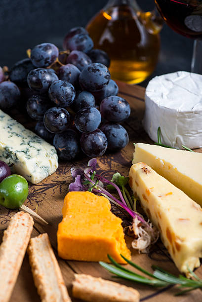 istock Cheese board with fresh grapes,herbs and olives 472860804