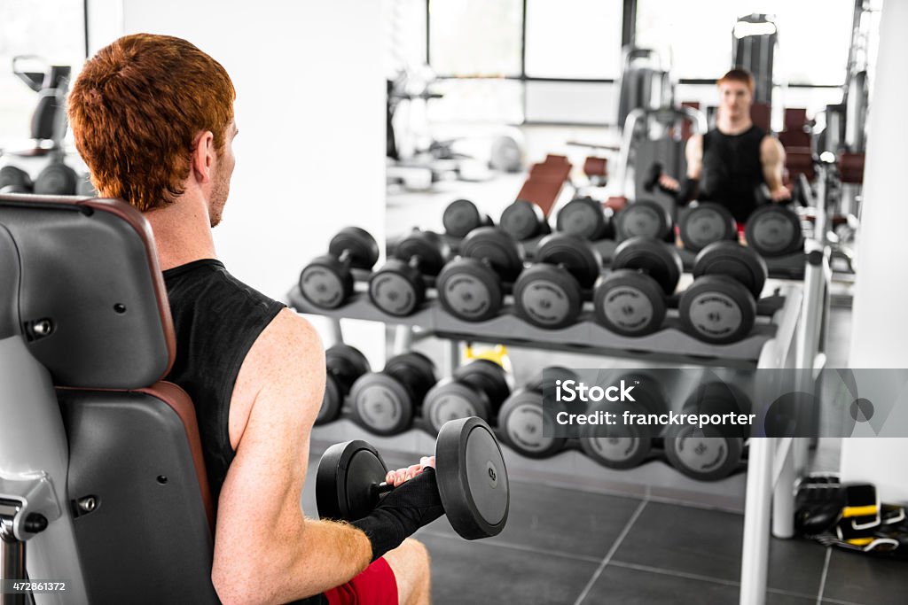 Red head man training with dumbell on gym 20-29 Years Stock Photo