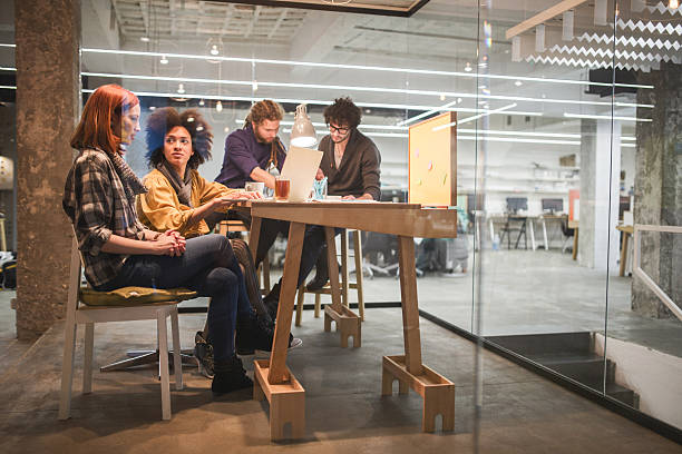 istock Small group of young creative people working in the office. 472864036