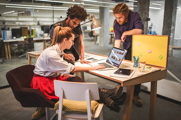 istock Creative team working in the office and using laptop together. 472864060