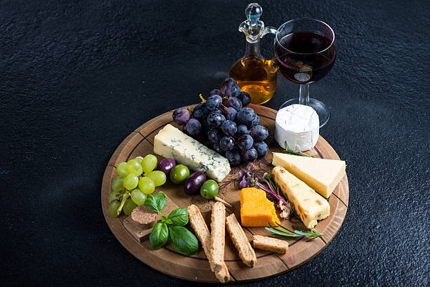 istock Cheese board with fresh grapes,herbs and olives 472865134