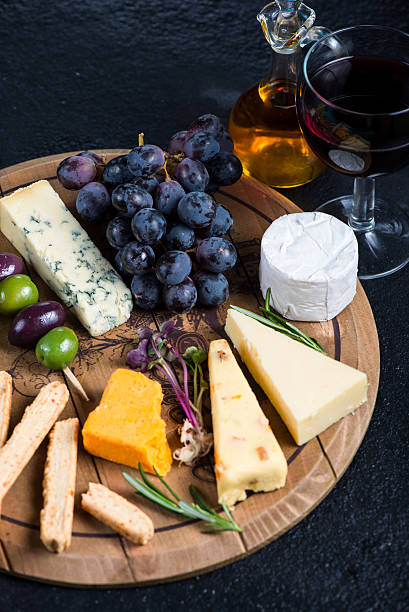 istock Cheese board with fresh grapes,herbs and olives 472865156