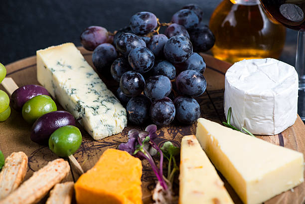 istock Cheese board with fresh grapes,herbs and olives 472865170