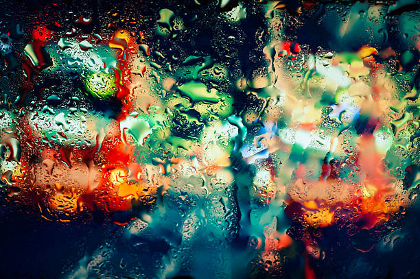 istock Night city through a wet window 472865288
