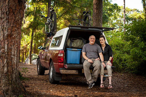 istock Middle aged couple loaded up for camp trip. 472865612