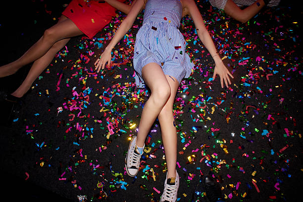 Confetti and human legs Female body with confetti on floor running shoes on floor stock pictures, royalty-free photos & images