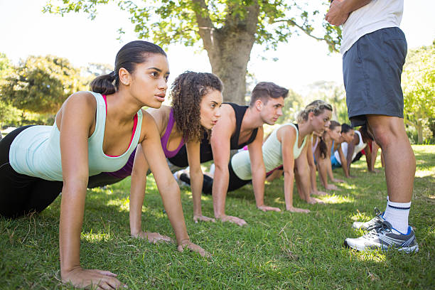 istock Fitness group planking in park 472869168