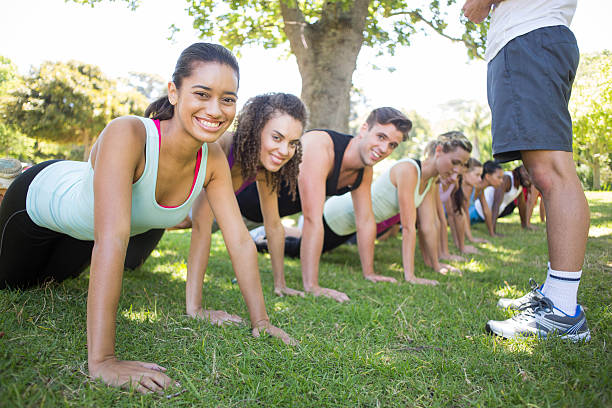 istock Fitness group planking in park 472869170