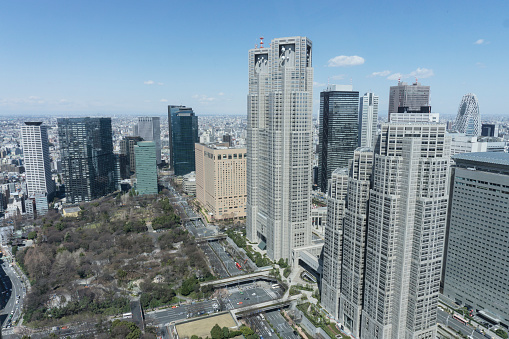 The city skyline of Tokyo, the capital city of Japan. Large skyscrapers dominate the vast cityscape.