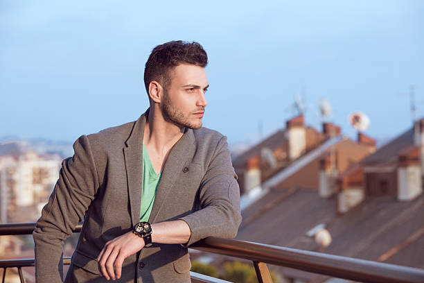 istock Young handsome businessman outdoors looking into distance 472869686