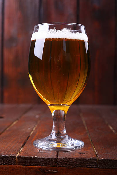 istock Glass of beer on wood 472870414