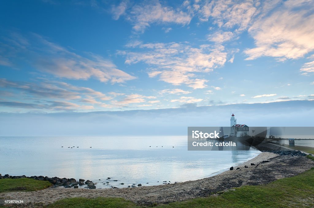 white lighthouse in morning white lighthouse in morning, Marken, Netherlands 2015 Stock Photo