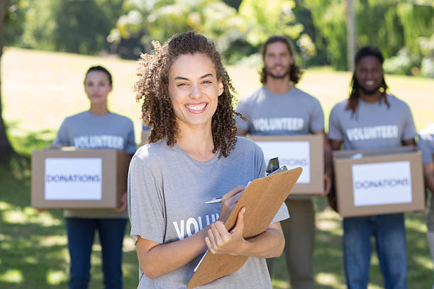 istock Happy volunteers in the park 472870850