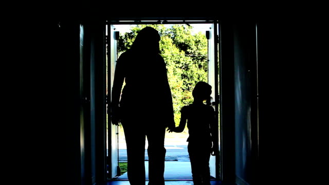 Woman and Chid walk hold hands