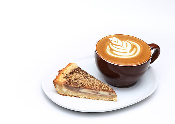 Cup of cappuccino and a piece of cake. Latte art stock photo