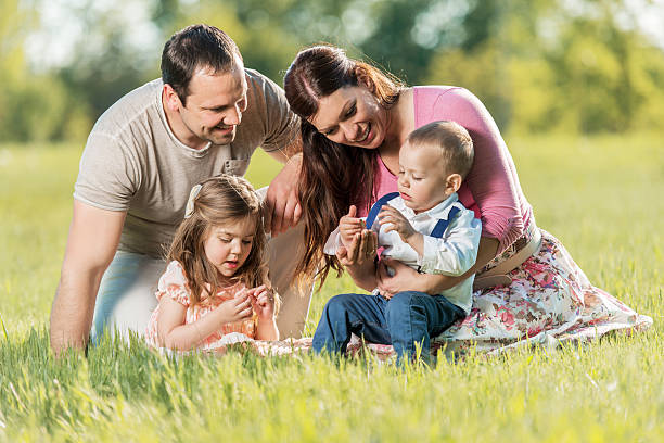 istock Happy parents bonding with their children during spring day. 472877188