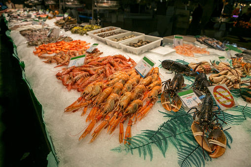 selling fresh seafood from mediteranean sea at famous boqueria fishmarket of barcelona spain
