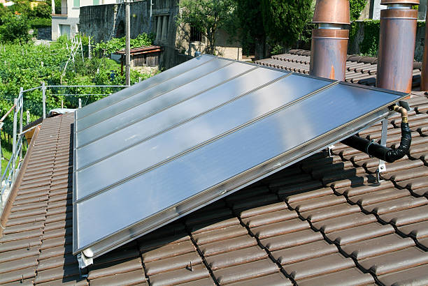 istock House with solar panels on roof 472886204