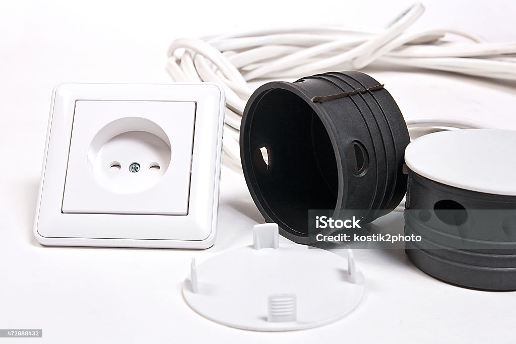 Electric sockets and power cable on white surface Electric wall socket, socket box, power cable on white background 2015 Stock Photo