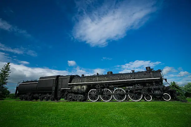 A large, black, iron antique steam train - known as a 484, or 'Northern' model of classic steam engine locomotive, commonly used in service in the early half of the 20th century.