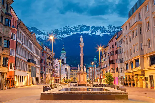Image of Innsbruck, Austria during twilight with European Alps in the background.