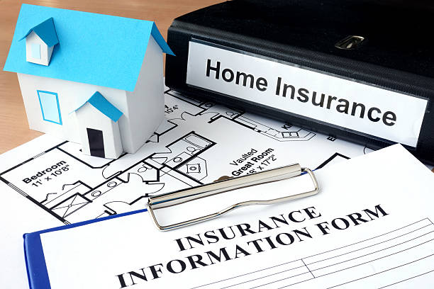 istock Model of house and folder with home insurance. 472893344