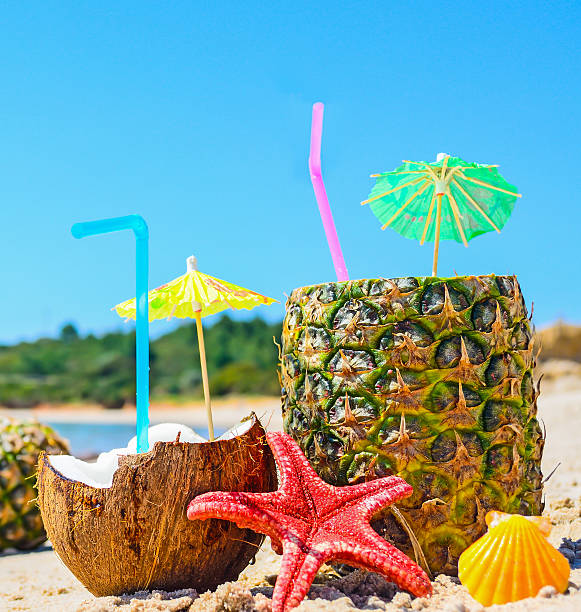 istock close up of pineapples and coconuts by the shore 472894438