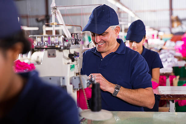 istock senior machinist sewing 472894478