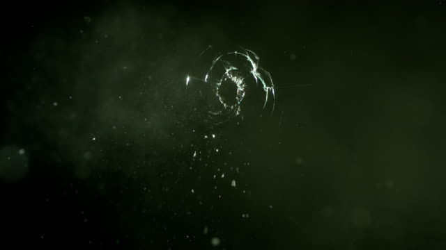 Glass is hit by bullet, slow motion
