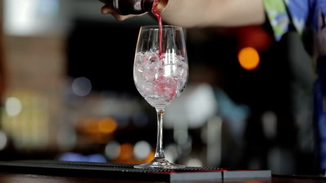 Bartender making red cocktail