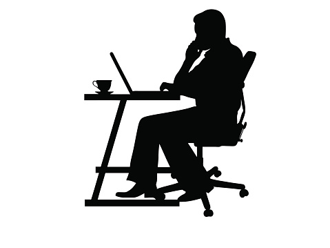 Silhouette of a man typing at a laptop isolated