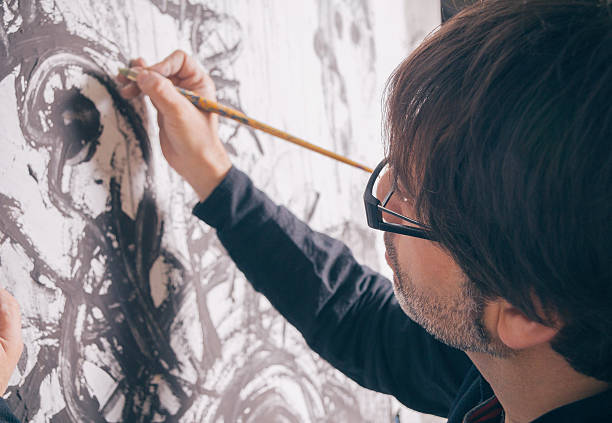 istock Painter artist working in modern oil canvas 472898120