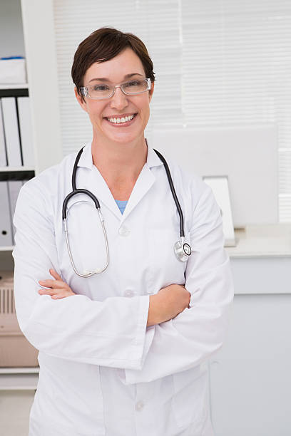 istock Smiling doctor with stethoscope and arms folded 472898634