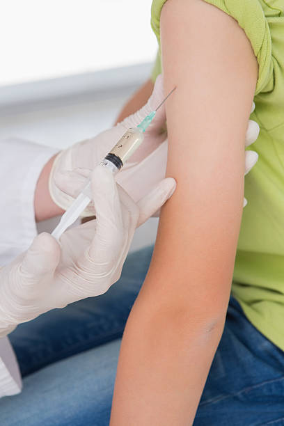 istock Doctor doing injection at little boy 472900148