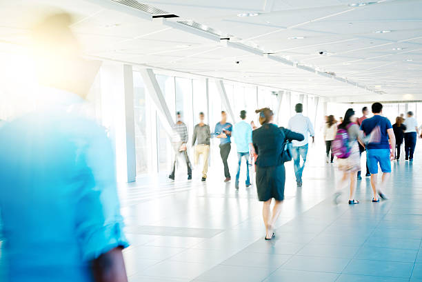 istock Motion Blur of People Walking in Corridor 472905978