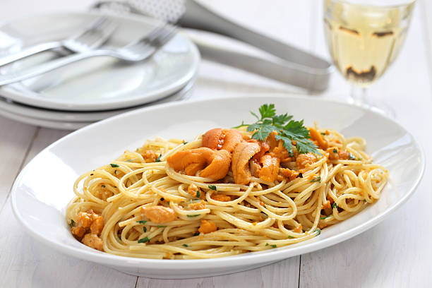 sea urchin pasta pasta with sea urchin roe, italian cuisine sea urchin stock pictures, royalty-free photos & images