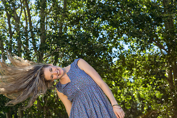 istock Pretty blonde smiling in the park 472910934