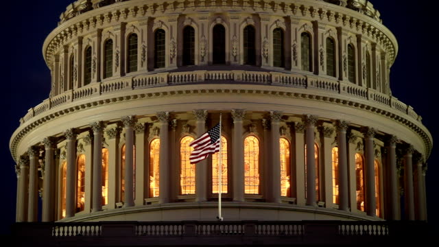 US Capitol dome at night with American flag - ECU