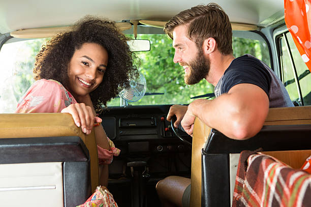 istock Hipster couple driving in camper van 472914878