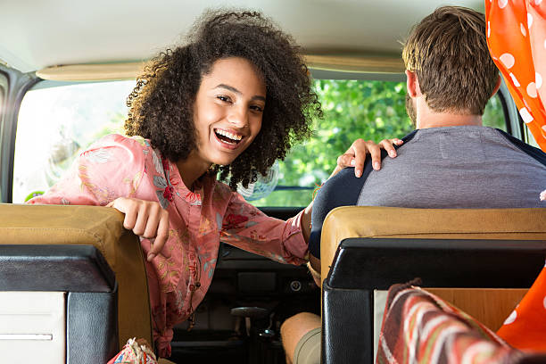 istock Hipster couple driving in camper van 472914912