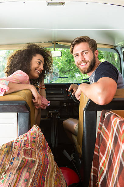 istock Hipster couple driving in camper van 472914914