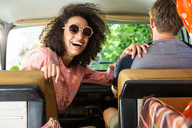 istock Hipster couple driving in camper van 472914916